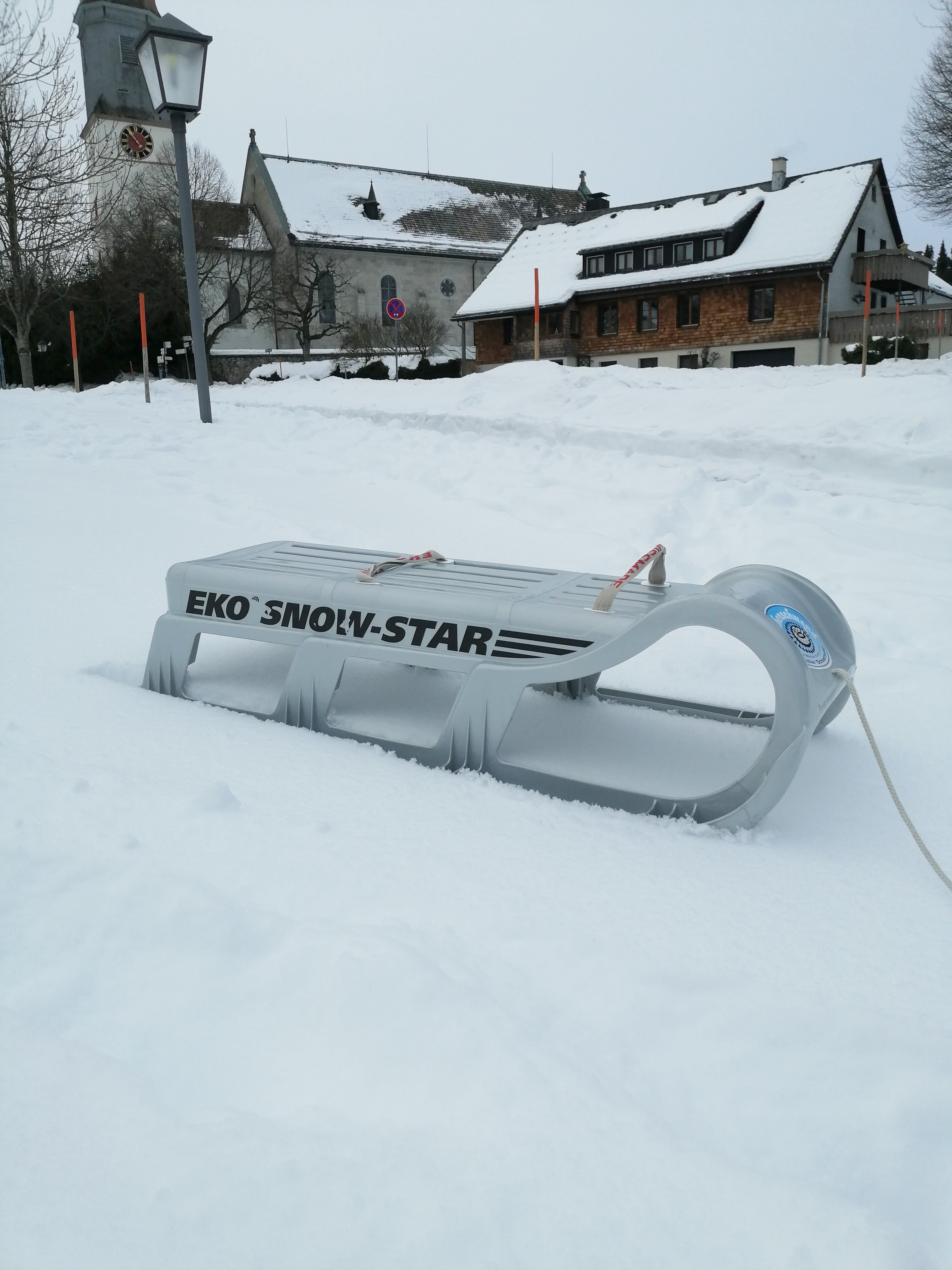 Schnee mit einem weißen Schlitten