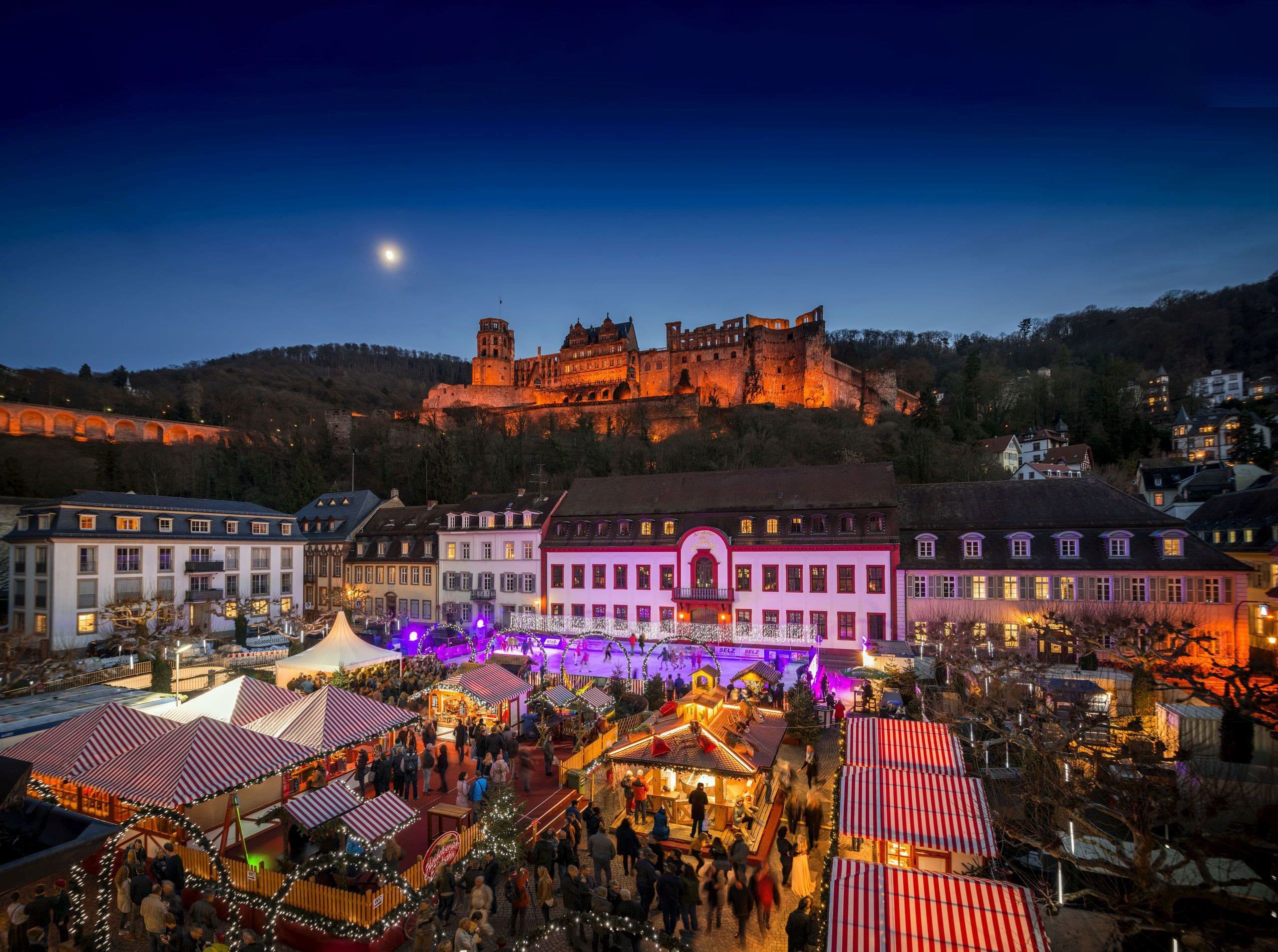Christmas market on Heidelberg's Karlsplatz with the castle in the background.