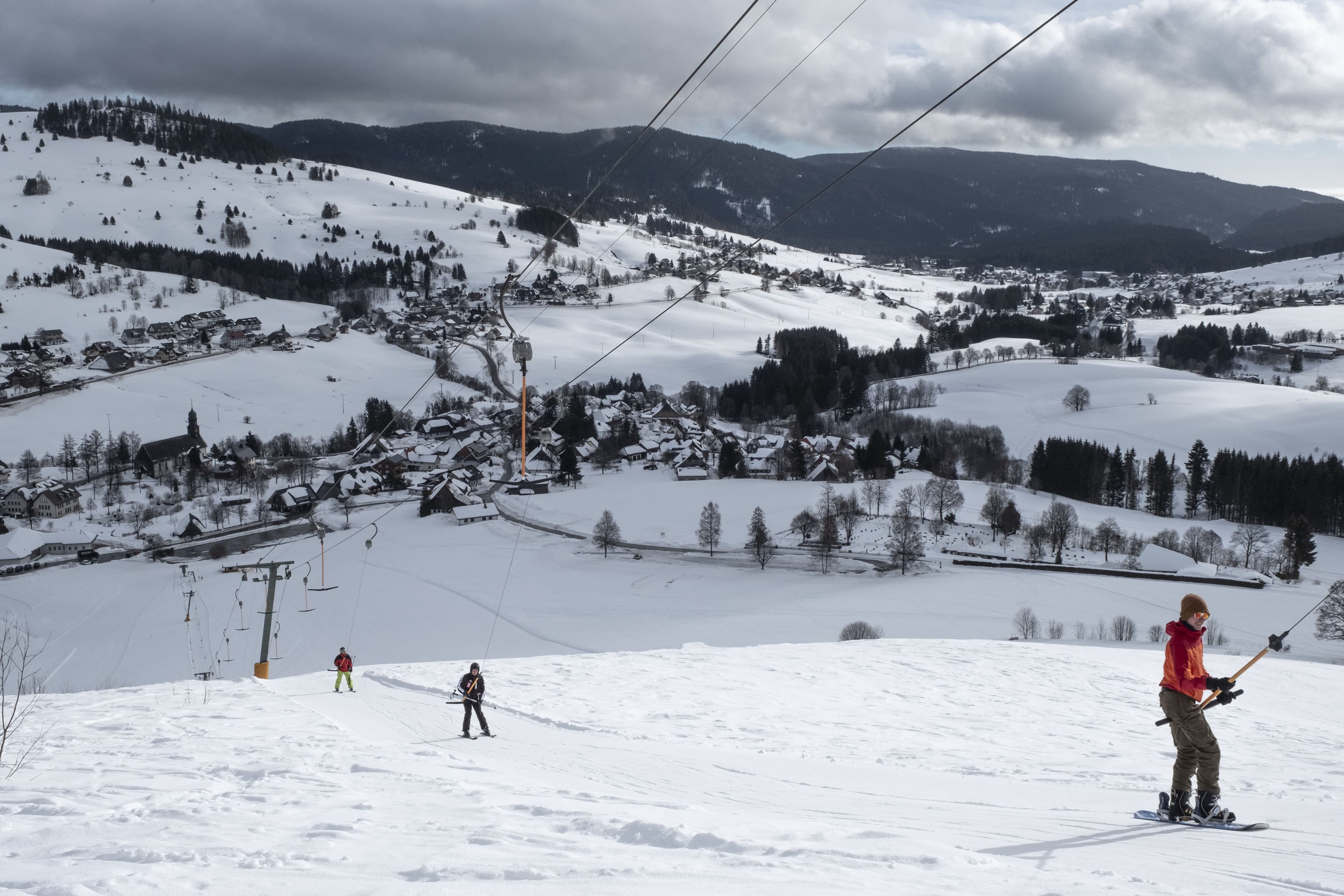 Skilift in einem Hochtal mit Skifahrer