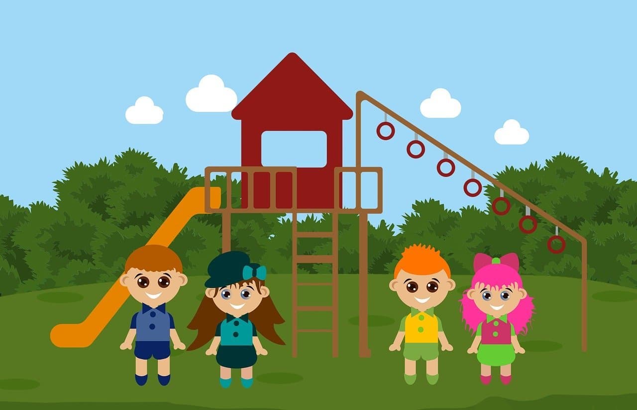 Vier Kinder vor dem Spielplatz stehend.